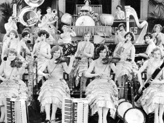 Women playing musical instruments on stage