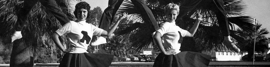 Black and white photo of male and female UA cheerleaders from the 1950s