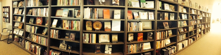 Photo of multiple book shelves displaying books published by the UA Press