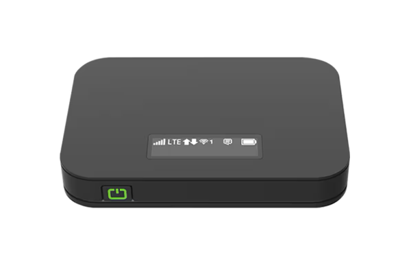 A dark gray, pocket-sized, T-mobile-branded mobile hotspot with its screen on, showing signal strength.